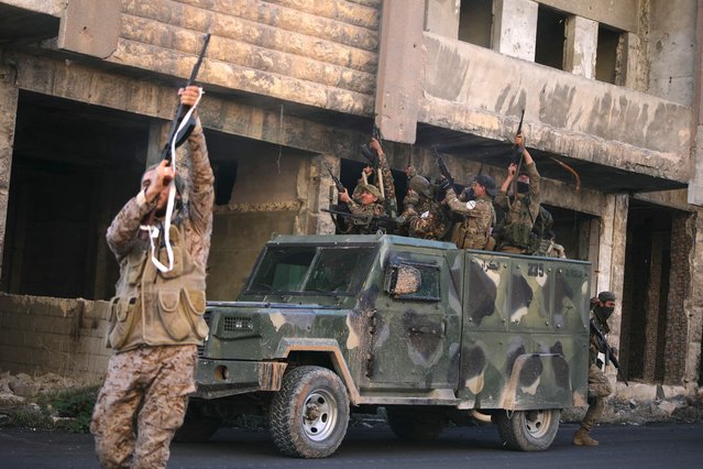 Anti-government fighters celebrate in a street in Maaret al-Numan in Syria's northwestern Idlib province on November 30, 2024. (Photo by Abdulaziz Ketaz/AFP Photo)