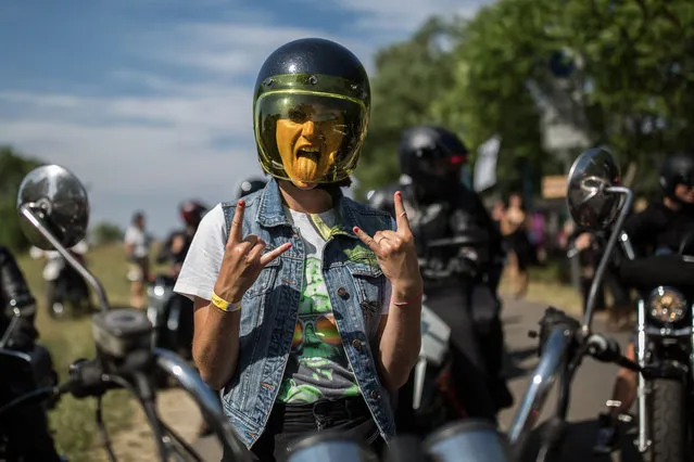 Participant poses as she waits for a ride out at the women's-only Petrolettes motorcycle festival on July 21, 2018 in Milmersdorf, near Berlin in Germany. (Photo by Maja Hitij/Getty Images)