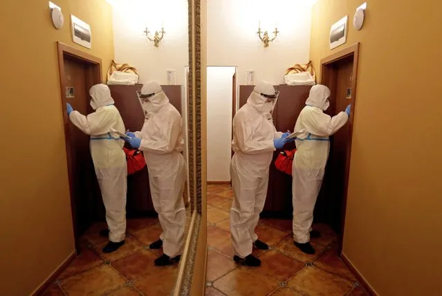 Healthcare workers enter a room to treat homeless people infected with the coronavirus disease (COVID-19) at a hotel, rented by Prague city hall, where homeless people who contracted COVID-19 can convalesce, in Prague, Czech Republic, March 22, 2021. (Photo by David W. Cerny/Reuters)