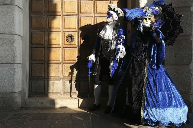 Masked revellers pose at Saint Mark's square during Carnival in Venice, February 8, 2015. (Photo by Stefano Rellandini/Reuters)
