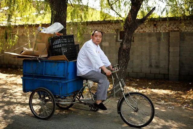 Scrap collector Zhang delivers recyclables on a tricycle to a recycling yard at the edge of Beijing, China, August 30, 2016. (Photo by Thomas Peter/Reuters)