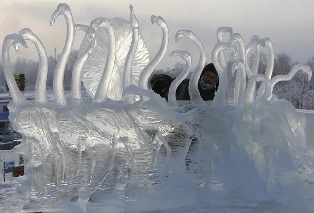 Alexander Parfyonov, a participant from the city of Barnaul, works on an ice sculpture called “The Melody of Sunset”, on the last day of the annual international festival of snow and ice sculptures “The Magical Ice of Siberia”, in Krasnoyarsk, Russia, January 17, 2016. (Photo by Ilya Naymushin/Reuters)