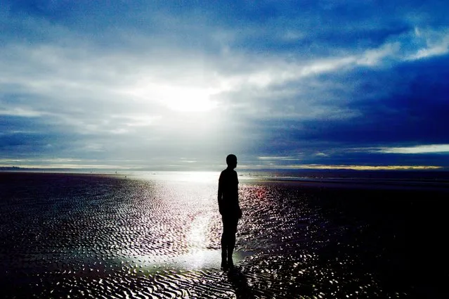 “Sunset over Crosby Beach, near Liverpool, with Antony Gormley’s art installation Another Place. The life-size cast iron sculptures attempt to replicate the the ebb and flow of the tide to discover people’s relationship with nature”. (Photo by Emma Keogh/Guardian Witness)