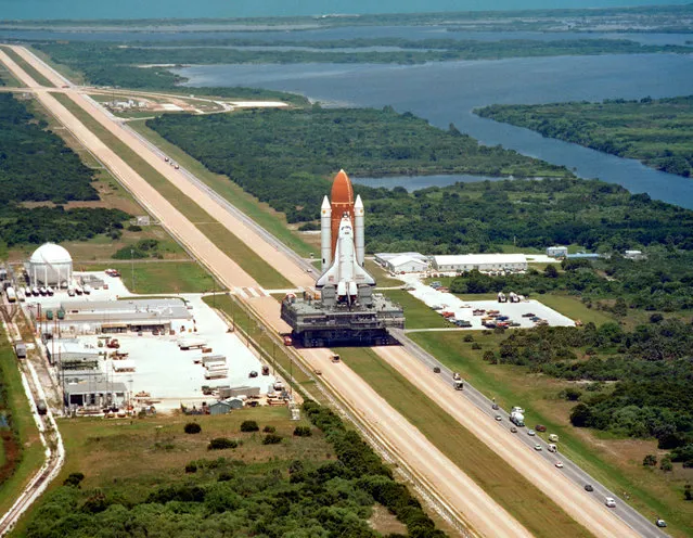 The shuttle Challenger is delivered to its launch pad at NASA's Kennedy Space Center atop a mobile crawler-transporter. (Photo by NASA)