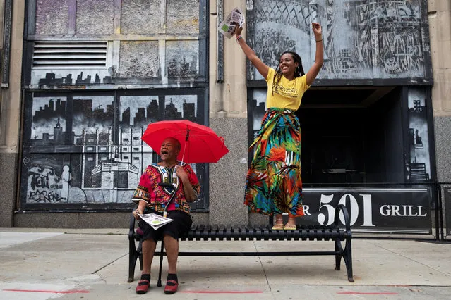 Briana Wilson, 22, dances on a bench as her grandmother, Jean Springer, cheers next to her during a parade to celebrate Juneteenth, which commemorates the end of slavery in Texas, two years after the 1863 Emancipation Proclamation freed slaves elsewhere in the United States, in Flint, Michigan, U.S., June 19, 2021. (Photo by Emily Elconin/Reuters)