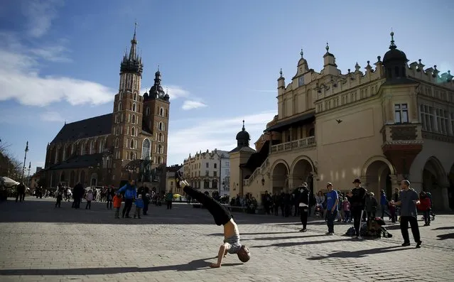 A man dances in front of St. Mary's Basilica at the Old Town Market Square in Krakow, Poland January 30, 2016. (Photo by Kacper Pempel/Reuters)