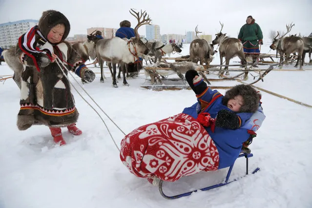 In this photo taken on Sunday, March 15, 2015, Nenets children attend the Reindeer Herder's Day holiday in the city of Nadym, in Yamal-Nenets Region, 2500 kilometers (about 1553 miles) northeast of Moscow, Russia. (Photo by Dmitry Lovetsky/AP Photo)