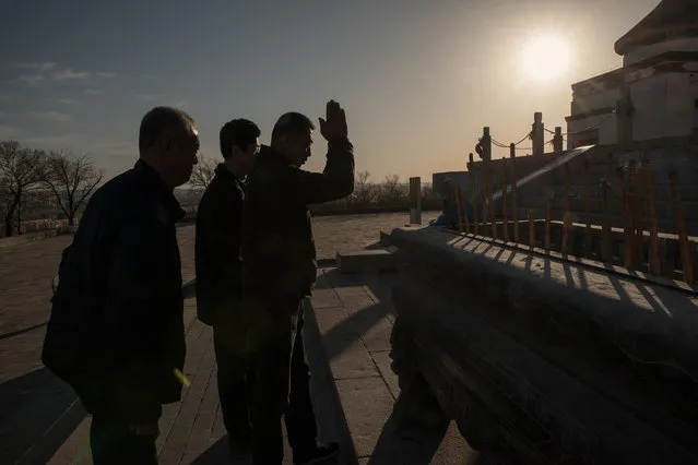 Visitors to a temple dedicated to Genghis Khan burn incense sticks as an offering to the Mongol hero. (Photo by Gilles Sabrie/The Washington Post)