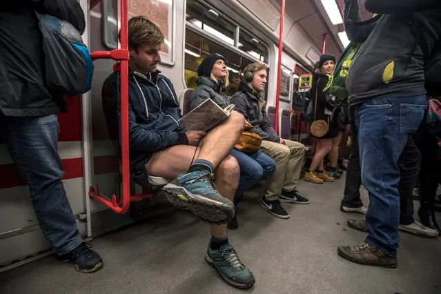 Young people wearing no pants participate in the “No Pants Subway Ride” in Prague, Czech Republic, 13 January 2019. No Pants Subway Ride is an annual global event started in New York, USA in 2002. (Photo by Martin Divisek/EPA/EFE)