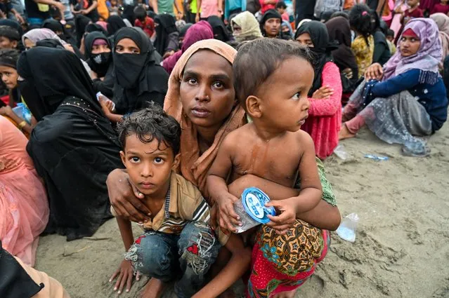 Newly-arrived Rohingya refugees wait to be transferred to a shelter in Batee beach, Aceh province, Indonesia, on November 15, 2023. At least 147 Rohingya refugees, mostly women and children, landed in Indonesia's westernmost province on November 15, a local official said, a day after nearly 200 others came ashore in the same area. (Photo by Chaideer Mahyuddin/AFP Photo)
