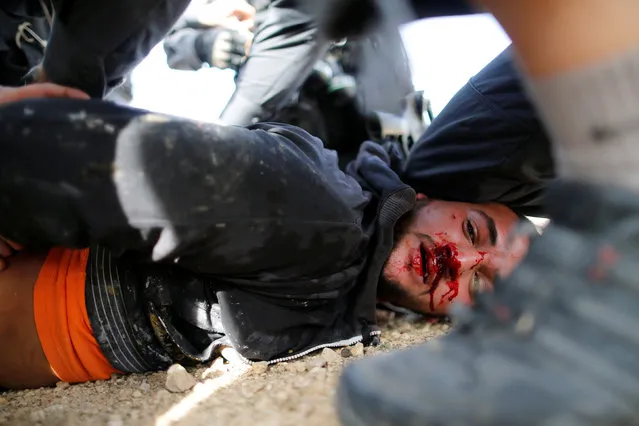 A man injured during clashes with Israeli police is seen on the ground in Umm Al-Hiran, a Bedouin village in Israel's southern Negev Desert, January 18, 2017. (Photo by Ammar Awad/Reuters)