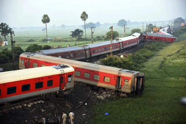 Coaches of the North-East Express passenger train that derailed late Wednesday near Raghunathpur railroad station in Buxar district of Bihar state, India, Thursday, October 12, 2023. The train was on its way to Assam state from New Delhi. (Photo by Aftab Alam Siddiqui/AP Photo)