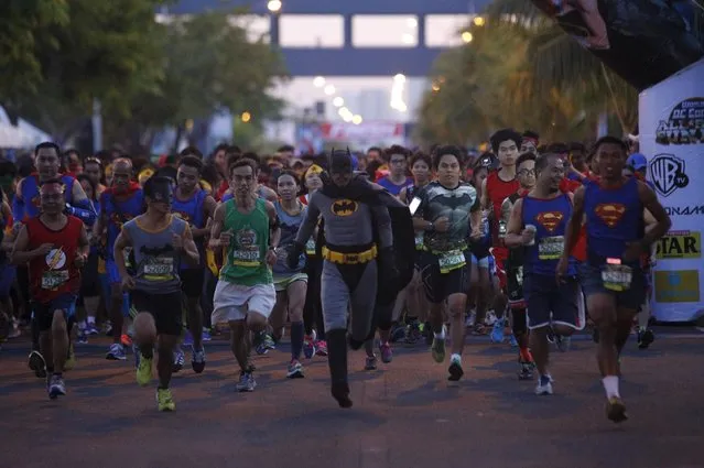 Runners wearing super heroes costumes take part in a DC Comics fun run in Manila April 18, 2015. To celebrate the anniversary of the publication of the very first Superman story, DC Comics are asking fans to help set a new world record for the largest global gathering of people dressed as DC Comics Super Heroes. (Photo by Romeo Ranoco/Reuters)