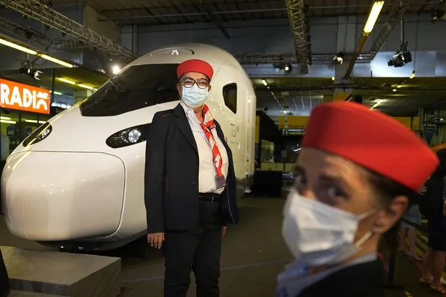 Train employees pose by a life-size replica of the next high-speed train TGV is pictured at the Gare de Lyon station Friday, September 17, 2021 in Paris. France unveils a super-fast, climate-friendly train of the future, the next generation of its high-speed TGV trains that have been emulated around the world. French President Emmanuel Macron and other government officials are holding a ceremony at the historic Gare de Lyon train station in Paris to mark 40 years since the unveiling of the first TGV, or “train a grand vitesse”. (Photo by Michel Euler/Pool via AP Photo)