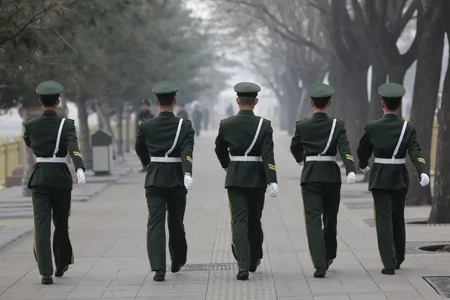 Paramilitary policemen march near the Great Hall of the People before delegates arrive for a meeting ahead of Saturday's opening ceremony of the National People's Congress (NPC), in Beijing, China March 4, 2016. (Photo by Damir Sagolj/Reuters)