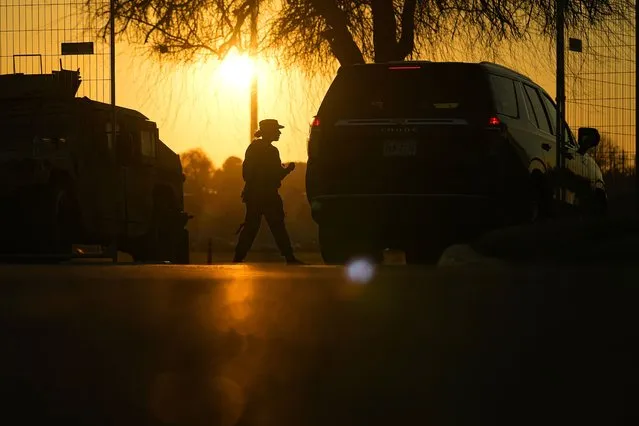 A guardsman checks a vehicle at the gate for Shelby Park, which troops from the Texas National Guard seized and began turning away federal immigration authorities, Thursday, February 1, 2024, in Eagle Pass, Texas. As tensions grow between Texas officials and the federal government over who can enforce immigration policies and how, some Republican leaders are pledging their support to the Lone Star state. (Photo by Eric Gay/AP Photo)