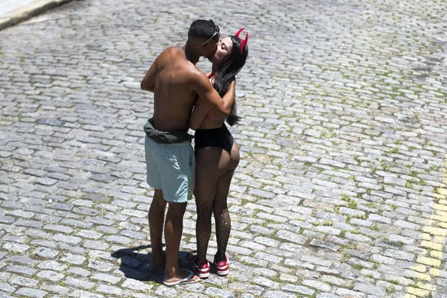 People kiss before the start of the Carmelitas street party on the first day of Carnival in Rio de Janeiro, Brazil, Friday, February 9, 2024. (Photo by Bruna Prado/AP Photo)