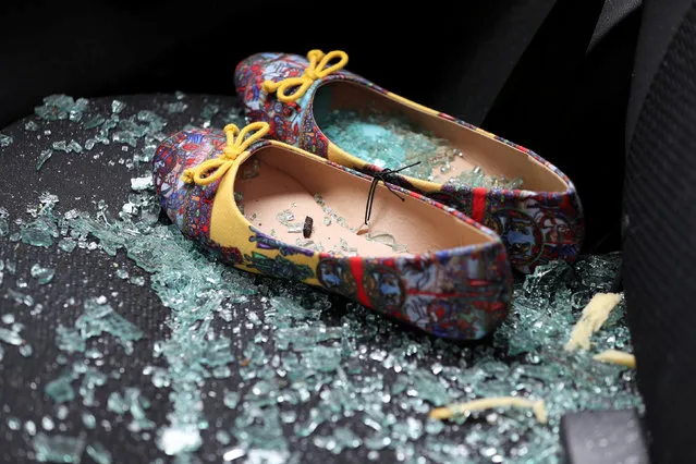 Shattered glass covers shoes left on the seat of a car that was damaged after a rocket hit a house north of Tel Aviv, Israel March 25, 2019. (Photo by Ammar Awad/Reuters)