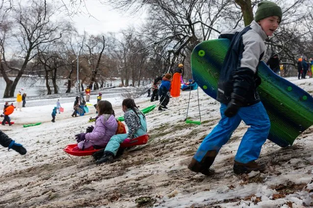 Children sled at a hill in Brooklyn's Prospect Park as a large winter storm makes its way across the area on February 13, 2024 in New York City. Much of the Northeast is experiencing snow, wind and freezing temperatures with many businesses closed and schools in New York City going remote for the day. (Photo by Spencer Platt/Getty Images)