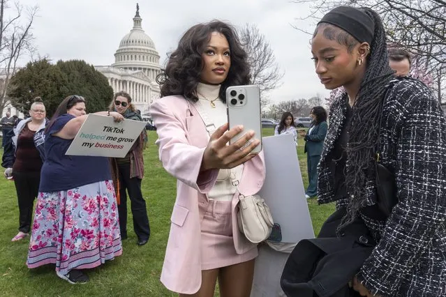 Devotees of TikTok, Mona Swain, center, and her sister, Rachel Swain, right, both of Atlanta, monitor voting at the Capitol in Washington, as the House passed a bill that would lead to a nationwide ban of the popular video app if its China-based owner doesn't sell, Wednesday, March 13, 2024. Lawmakers contend the app's owner, ByteDance, is beholden to the Chinese government, which could demand access to the data of TikTok's consumers in the U.S. (Photo by J. Scott Applewhite/AP Photo)