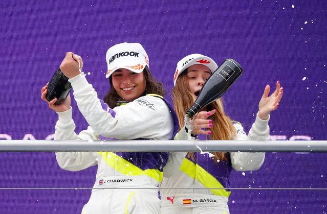 Marta Garcia (R) of Spain loses the champgane bottle standing on the podium next to winner Jamie Chadwick of Great Britain after the first race of the W Series at Hockenheimring on May 04, 2019 in Hockenheim, Germany. W Series aims to give female drivers an opportunity in motorsport that hasn’t been available to them before. The first race of the series, which encompasses six rounds on the DTM support programme, is at the Hockenheimring on May 3rd and 4th. (Photo by Kai Pfaffenbach/Reuters)