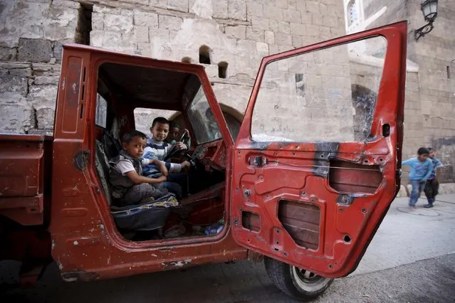 Boys sit inside a vehicle in the old quarter of Yemen's capital Sanaa March 8, 2016. (Photo by Khaled Abdullah/Reuters)