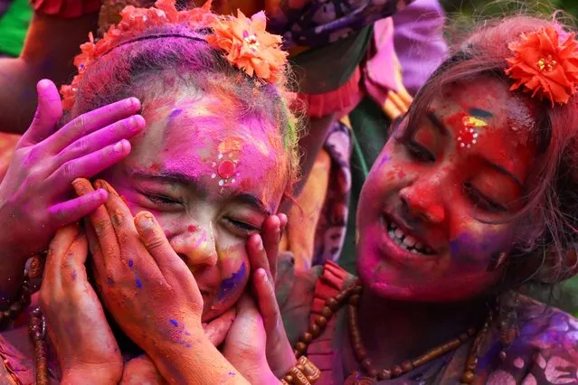 Girls smeared with “Gulal” as they celebrate Holi, the Hindu spring festival of colours, in Kolkata on March 25, 2024. (Photo by Dibyangshu Sarkar/AFP Photo)