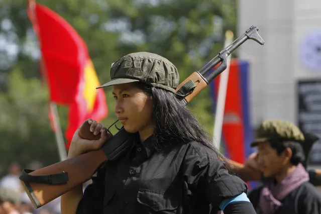 A Cambodian student of Royal University of Fine Arts performs during a reenactment of torture and execution committed by the Khmer Rouge during their reign of terror in the 1970s to mark the annual Day of Anger at Choeung Ek, a former Khmer Rouge “killing field”, on the outskirt of Phnom Penh, Cambodia Wednesday, May 20, 2015. Cambodia on Wednesday marked the 36th anniversary of the Day of Anger to remember the atrocities committed during the Khmer Rouge's 1975-79 era. (Photo by Heng Sinith/AP Photo)