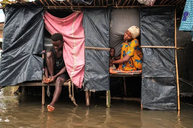 Uwurukundo Zilfa (R) sits next to her husband and kid inside their temporary shelter after being displaced following flash floods in the Gatumba district of Bujumbura, on April 19, 2024. The government of Burundi and the United Nations have launched an appeal for financial aid to cope with the “devastating effects” of months of relentless rainfall that has displaced nearly 100,000 people. East Africa has been experiencing torrential rains in recent weeks that have cost the lives of at least 58 people in Tanzania in the first half of April, and 13 people in Kenya. (Photo by Tchandrou Nitanga/AFP Photo)