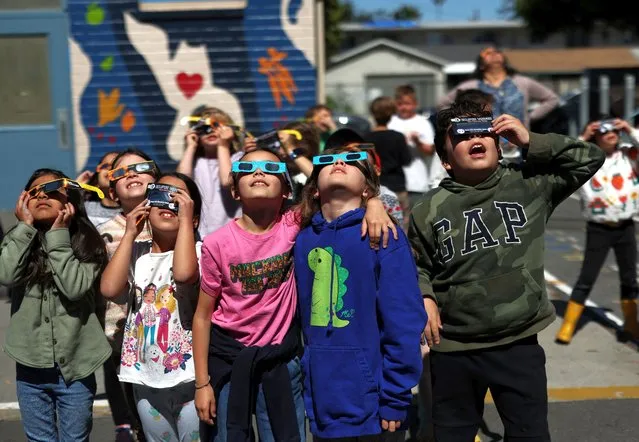 Students watch a partial solar eclipse at Benjamin Franklin Elementary Magnet School in Glendale, California on April 8, 2024. (Photo by Mario Anzuoni/Reuters)