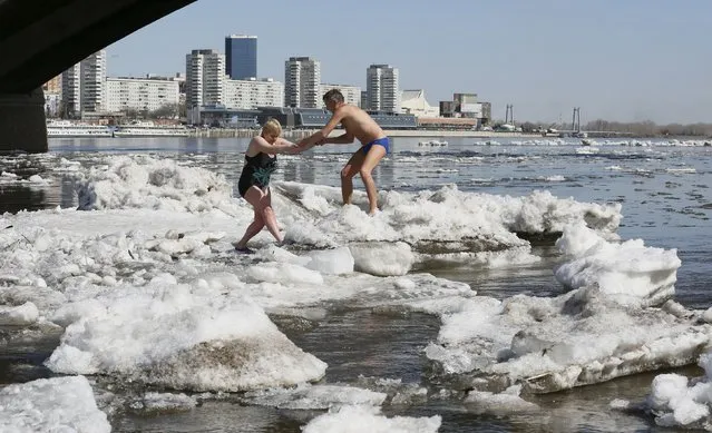 Members of the Cryophile winter swimmers' club walk on ice floes during an ice drift on the Yenisei river in Krasnoyarsk, Siberia, Russia, April 20, 2016. (Photo by Ilya Naymushin/Reuters)