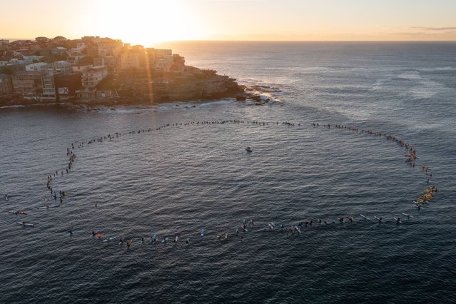 Members of the Bondi Board Riders Club, various local sporting clubs, and lifeguards participate in a paddle-out at Bondi Beach to honor and remember the victims of the Westfield Bondi Junction stabbings in Sydney, Australia, 23 April 2024. (Photo by Steven Saphore/EPA)