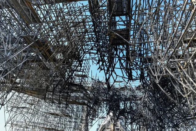 Parts of a destroyed scaffolding are pictured at the Notre-Dame de Paris Cathedral, July 17, 2019 in Paris. (Photo by Stephane de Sakutin/Pool via AP Photo)