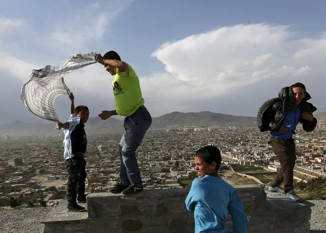Afghan boys enjoy on a hilltop during a windy day in Kabul, Afghanistan April 26, 2016. (Photo by Mohammad Ismail/Reuters)