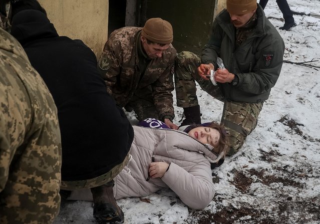 Servicemen treat a woman wounded by a Russian missile strike, amid Russia's attack on Ukraine, in Kramatorsk, Ukraine February 2, 2023. (Photo by Vyacheslav Madiyevskyy/Reuters)