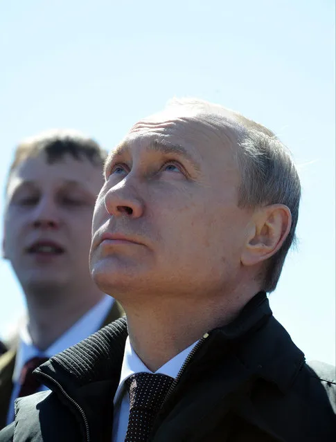 Russian President Vladimir Putin watches a launch of a Russian Soyuz 2.1a rocket carrying Lomonosov, Aist-2D and SamSat-218 satellites at the new Vostochny cosmodrome outside the city of Uglegorsk, about 200 kilometers (125 miles)  from the city of Blagoveshchensk in the far eastern Amur region Thursday, April 28, 2016. (Photo by Mikhail Klimentyev/Sputnik, Kremlin Pool Photo via AP Photo)