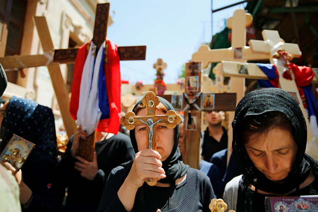 Orthodox Christian worshippers hold crosses before a procession along the Via Dolorosa on Good Friday during Holy Week in Jerusalem's Old City April 29, 2016. (Photo by Ammar Awad/Reuters)