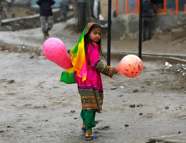 An Afghan girl holds balloons during Newroz Day celebrations in Kabul, Afghanistan on March 21, 2017. (Photo by Omar Sobhani/Reuters)