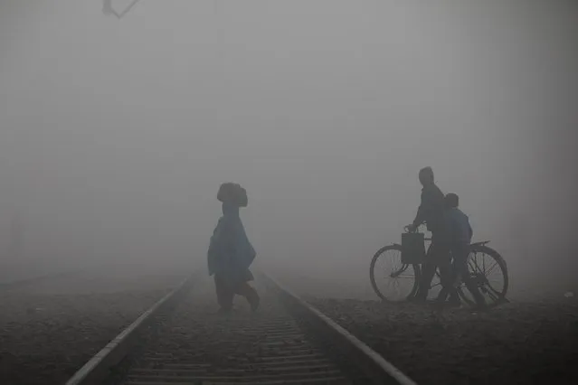 Indian people crosses a railway track on a foggy morning near a railway station in Ghaziabad, on the outskirts of New Delhi in India, February 01, 2022. The Indian government, meanwhile, presented the Union Budget for the next year, outlining the government spending and income while hoping to log a GDP growth of over 9%, which is highest among major economies. (Photo by Amarjeet Kumar Singh/Anadolu Agency via Getty Images)