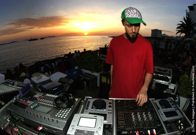 A DJ spins records at a party at Cafe Del Mar in San Antonio