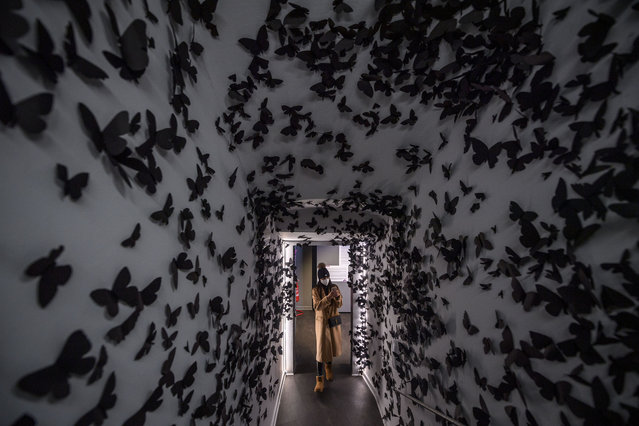 A visitor looks at the “Black Cloud Fashion” by artist Carlos Amorales, as part of the “Crazy: Madness In Contemporary” Art exhibition, at Chiostro del Bramante, on February 19, 2022 in Rome, Italy. The exhibition project titled “Crazy: La Follia nel Arte Contemporanea”, curated by Danilo Eccher is scheduled from February 19, 2022 to March 8, 2023. (Photo by Antonio Masiello/Getty Images)