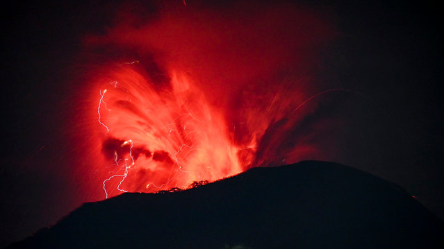 A handout photo made available by the Vulcanology and Geological Disaster Mitigation Center of the Indonesian Ministry of Energy and Mineral Resources (PVMBG) shows Mount Ibu volcano spewing volcanic materials during an eruption in West Halmahera, North Maluku, Indonesia, 06 June 2024. The volcano erupted twice on 06 June 2024, releasing volcanic clouds and red lava up into the air during the eruptions. Mount Ibu remains on the highest alert level according to PVMBG officials. (Photo by PVMBG/EPA/EFE)