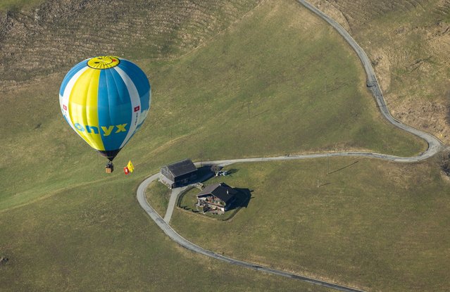 A balloon takes part in the 44th International Hot Air Balloon Festival in Chateau-d'Oex, Switzerland on January 25, 2024. (Photo by Denis Balibouse/Reuters)