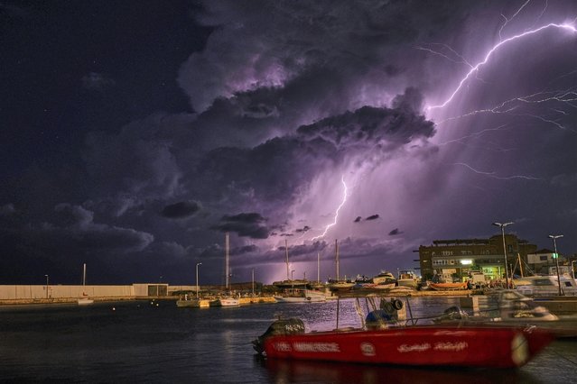 Lightning streaks across the skies over the coastal port city of Batroun, some 43km north of the Lebanese capital Beirut on December 6, 2023. (Photo by Ibrahim Chalhoub/AFP Photo)