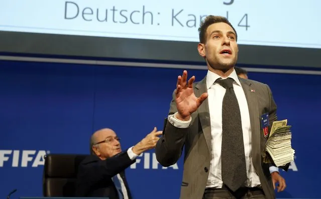 British comedian known as Lee Nelson holds banknotes in front of FIFA President Sepp Blatter (L) at a news conference after the Extraordinary FIFA Executive Committee Meeting at the FIFA headquarters in Zurich, Switzerland July 20, 2015. World football's troubled governing body FIFA will vote for a new president, to replace Sepp Blatter, at a special congress to be held on February 26 in Zurich, the organisation said on Monday. (Photo by Arnd Wiegmann/Reuters)