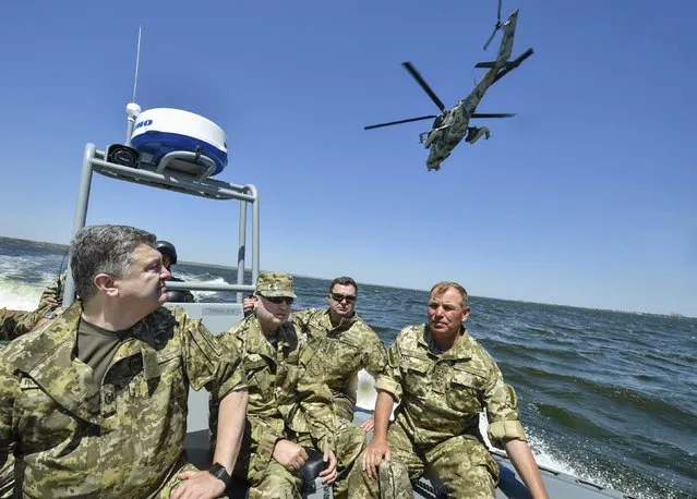 Ukraine's President Petro Poroshenko (L) inspects a military drill with the Secretary of the National Security and Defense Council of Ukraine Oleksandr Turchynov (2nd L), in the waters of the Black Sea in Mykolaiv region, Ukraine, July 21, 2015. (Photo by Mykola Lazarenko/Reuters/Ukrainian Presidential Press Service)