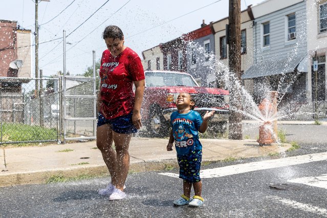 Alexandra Figueroa, 33, is cooling off in the summer heat with her son Rubannyel Soto, 3, in Philadelphia, Pa., on Tuesday, July 16, 2024. (Photo by Tyger Williams/AP Photo)