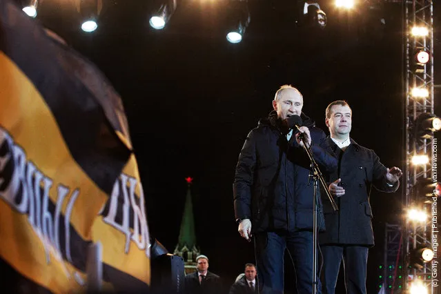 Russian Prime Minister and presidential candidate Vladimir Putin speaks as current President Dmitry Medvedev (R) listens during a rally after Putin claimed victory in the presidential election at the Manezhnya Square March, 4, 2012 in Moscow, Russia