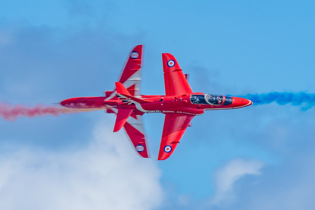 The picture dated July 6, 2024 shows the Red Arrows performing over Swansea Bay at the Wales Airshow. Thousands of people watched the stunning aerobatic display at the event, which has been running since 2009. Visitors have the chance to see parachute displays, helicopters and a huge range of aircraft over the two-day event. (Photo by Caroline Haycock/Bav Media)