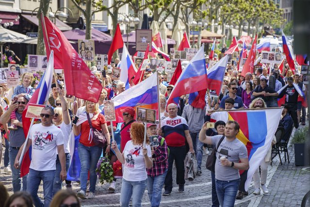 Carrying Russian flags and those of the defunct USSR, hundreds of people marched through the inner city during a pro-Russian demonstration under the slogan “Commemorative action for war victims”, in Frankfurt, Germany, Sunday, May 8, 2022. (Photo by Frank Rumpenhorst/dpa via AP Photo)